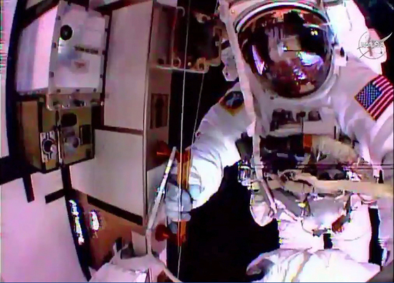 Spacewalker Kjell Lindgren inspects Scott Kelly for ammonia residue outside the International Space Station as they wait for ammonia to vent from cables they used over the course of their "high-flying plumbing" excursion to reconfigure and top off space station cooling systems Nov.