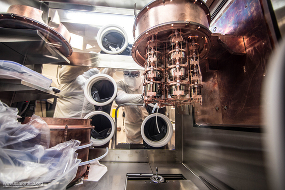 Delicate work assembling the Majorana cryostat is done inside a glovebox. The cryostat contains strings of hockey puck shaped germainium detectors.