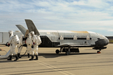 Recovery crew members process the X-37B Orbital Test Vehicle at Vandenberg Air Force Base after the program’s third mission complete.
