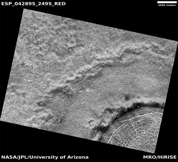 Polygonal terrain within and around a polar crater on Mars (monochrome red-filter HiRISE image.)