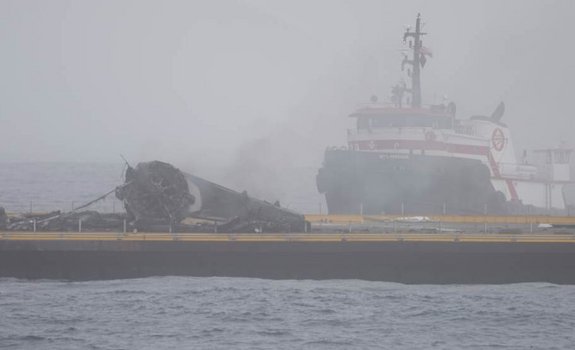 The first stage of SpaceX's Falcon 9 rocket is seen here lying on its side on the drone ship "Just Read the Instructions" after a near-miss landing attempt on Jan. 17, 2016.