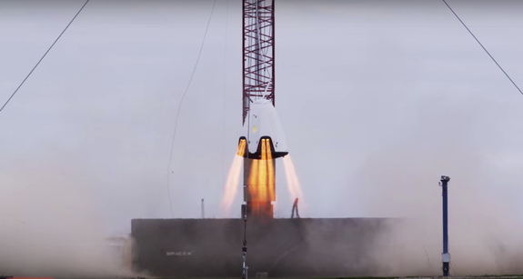SpaceX's Dragon 2 crew capsule prototype hovers during a rocket motor test in November 2015 in this still from a SpaceX video released in January 2016.