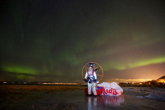 Paraglider Horacio Llorens stands beneath the shimmering northern lights after a flight in Tromsø, Norway, on Jan. 6, 2016.