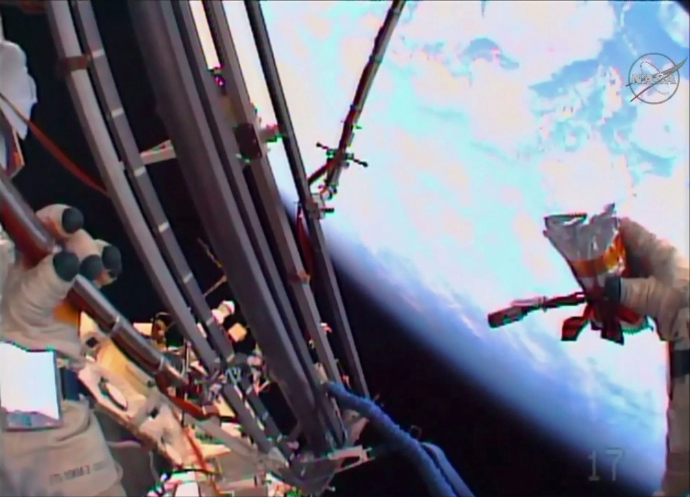 Russian Spacewalkers Maintain Experiments, Launch Ceremonial Flash Drive Into Space