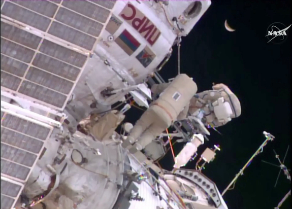 For their last task of the Feb. 2 spacewalk, cosmonauts Yuri Malenchenko and Sergey Volkov applied a new thermal control film to a sample board, testing a system that could help renovate the Russian segment of the International Space Station.