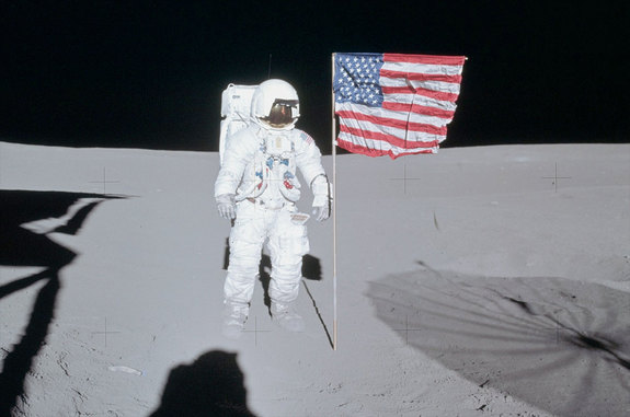 Apollo 14 moonwalker Ed Mitchell poses next to the American flag that he and Alan Shepard planted on the moon in February 1971. 