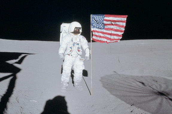 Apollo 14 moonwalker Ed Mitchell poses next to the American flag that he and Alan Shepard planted on the moon in February 1971.