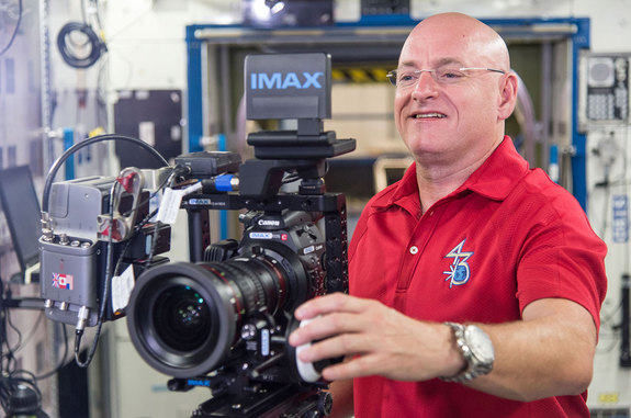 Astronaut Scott Kelly seen training on how to use IMAX's cameras before his yearlong space station mission.