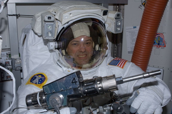 NASA astronaut Ron Garan checks out tools in the International Space Station's Quest airlock prior to the July 12, 2011, spacewalk he performed with crewmate Mike Fossum (not pictured). 