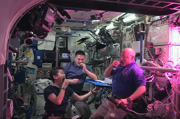 NASA astronauts Scott Kelly (right) and Kjell Lindgren (center) with Japanese astronaut Kimiya Yui snack on freshly harvested, space-grown red romaine lettuce as part of the Veggie experiment on the International Space Station.