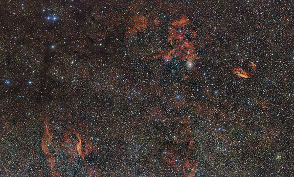 In this image from the European Southern Observatory, hidden stars illuminate the crimson gas clouds of the RCW 106 region in the southern constellation Norma (The Carpenter's Square).
