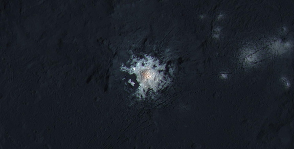 The bright spots in Occator Crater on dwarf planet Ceres appear here with enhanced color, in a view from NASA's Dawn spacecraft. Image released March 22, 2016.