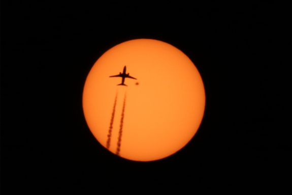 The heart-shaped sunspot AR 2529 sits beneath the wingtip of a plane crossing the sun's face in this photo, which was captured by Alexander Krivenyshev of New York City on April 13, 2016.