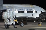 An Air Force X-37B robotic space plane is shown after it has landed at Vandenberg Air Force Base in California. The fourth mission of the program is now underway and nearing a year in Earth orbit.