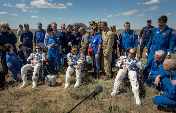 Tim Peake of the European Space Agency, left, Yuri Malenchenko of Roscosmos center, and Tim Kopra of NASA sit in chairs outside the Soyuz TMA-19M spacecraft just minutes after they landed in a remote area near the town of Zhezkazgan, Kazakhstan on Saturday, June 18, 2016 in this NASA photo by photographer Bill Ingalls. The trio spent six month living and working on the International Space Station as part of Expedition 47.