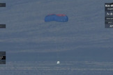 Blue Origin's New Shepard space capsule descends back to Earth under two of its three main parachutes during a test of its two-chute landing capabilities on June 19, 2016.