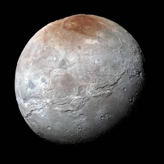 Pluto's largest moon, Charon, has a dull, gray surface marred by a bright-red spot at the poles. As the red material is deposited, radiation may slowly dull its color, changing it to gray like the rest of the moon.