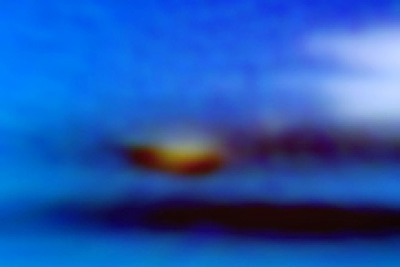 A close-up of Neptune's newest dark vortex and its companion clouds.