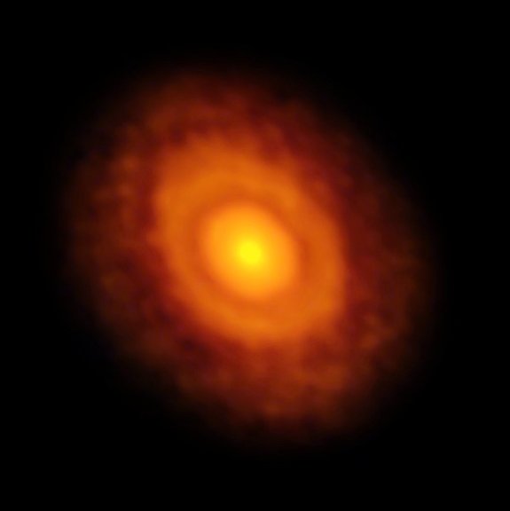 ALMA's radio image of the star V883 Orionis and its disk of gas, dust and debris — a precursor of planet formation. The water snow line is visible as a ring around the disk — the first dark ring after the central brightness of the star — at about the average distance Pluto lies from the sun.