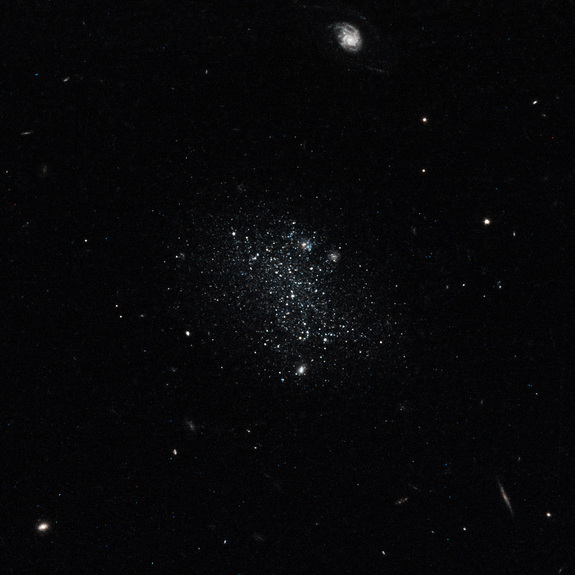 This color composite taken on Oct. 30, 2014 by the Hubble Space Telescope shows what the dwarf galaxy Pisces A would look like to the naked eye: a dim cluster of light blue stars.