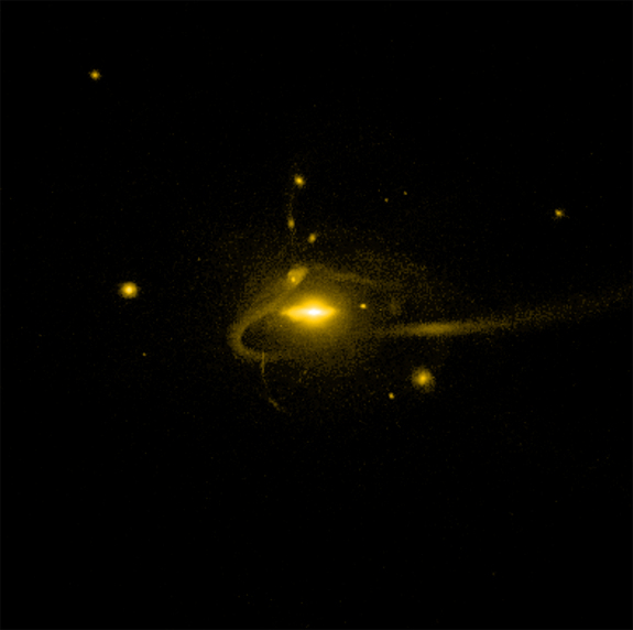 This image is from a new computer simulation is the first to correctly predict the number of dwarf galaxies observed near the Milky Way galaxy today. The streak is a tidal tail from a torn-apart dwarf galaxy.