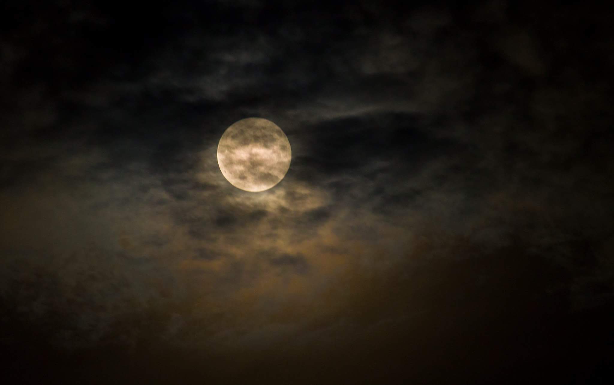 Glowing behind the clouds