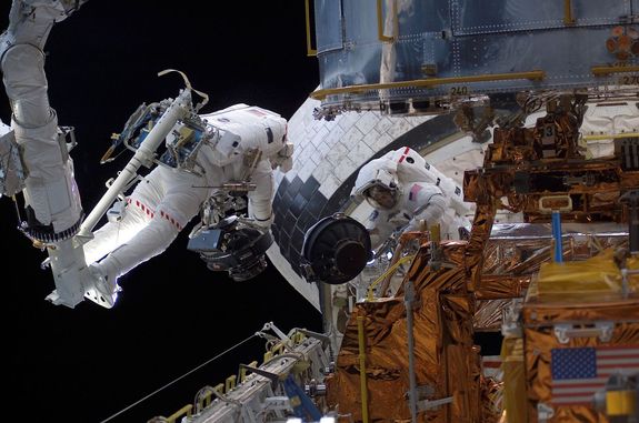 Mike Massimino and fellow NASA astronaut Jim Newman worked to replace a reaction wheel assembly on the Hubble Space Telescope in March of 2002.