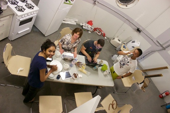 Mars 160 crewmembers prepare for lunch inside The Mars Society's Mars Desert Research Station in Utah. They are (from left): Anushree Srivastava, Biologist, of India; Annalea Beattie, Artist, of Australia; Claude-Michel Laroche, Engineer, of France; and Yusuke Murakami, Executive Officer, of Japan.