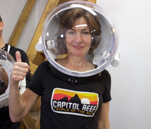 Mars 160 crewmember Annalea Beattie tries on a new spacesuit helmet for outside excursions.