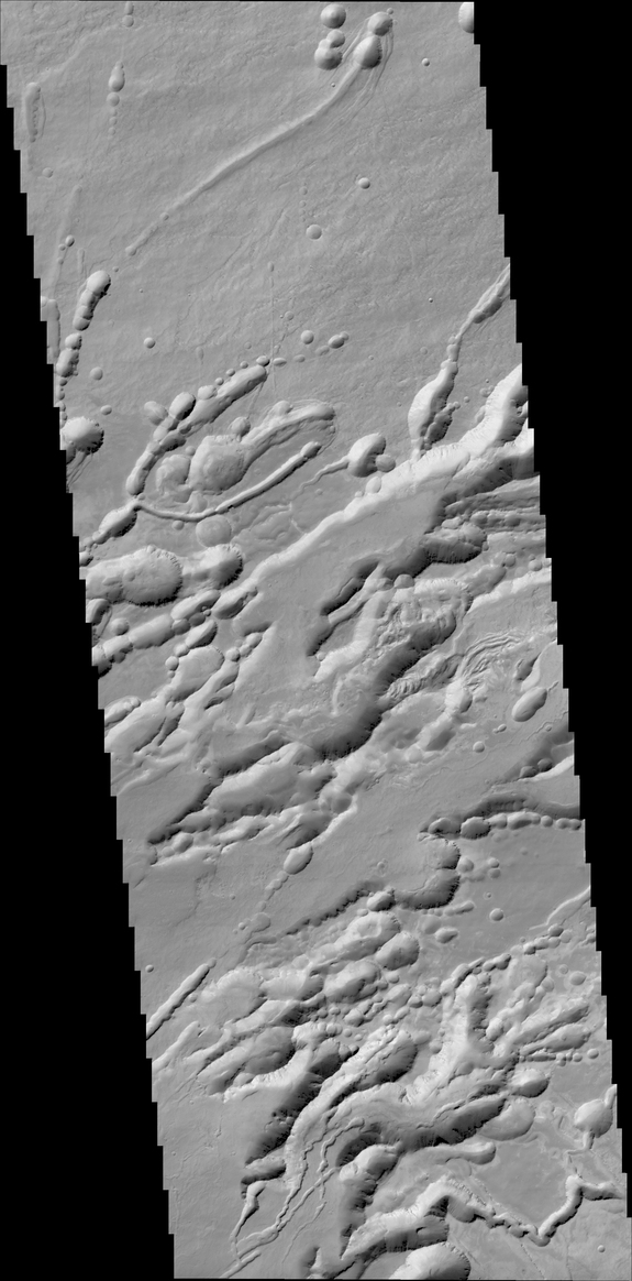A structure called Arsia Chasmata _n the flanks of _ne of the large Martian volcanoes, Arsia Mons. This view was created by the Colour and Stereo Surface Imaging System (CaSSIS) aboard the European Space Agency's ExoMars Trace Gas Orbiter. The width of the image is around 16 miles (25 kilometers). The formation is volcanic in origin, and pit craters are visible. 