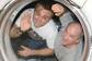 Two American astronauts waving from Russian-built Soyuz spacecraft