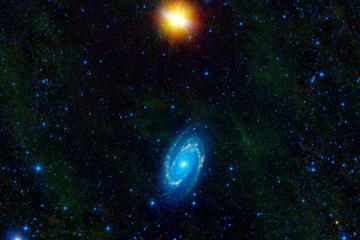 This image from NASA's WISE telescope features the galaxies Messier 81 and Messier 82, which swept by each other a few hundred million years ago, and will likely continue to twirl around each other before eventually merging into a single galaxy.