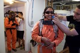 Geologist Jon Clarke and biologist Anushree Srivastava being suited up by  Yusuke Murakami and Crew Engineer Claude- Michel Laroche for a science EVA at the Mars Desert Research Station, Utah. 