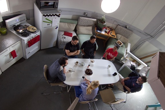 Mars 160 crewmembers chat around a table at the Mars Desert Research Station.