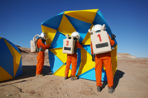 Assembling the dome in spacesuits.